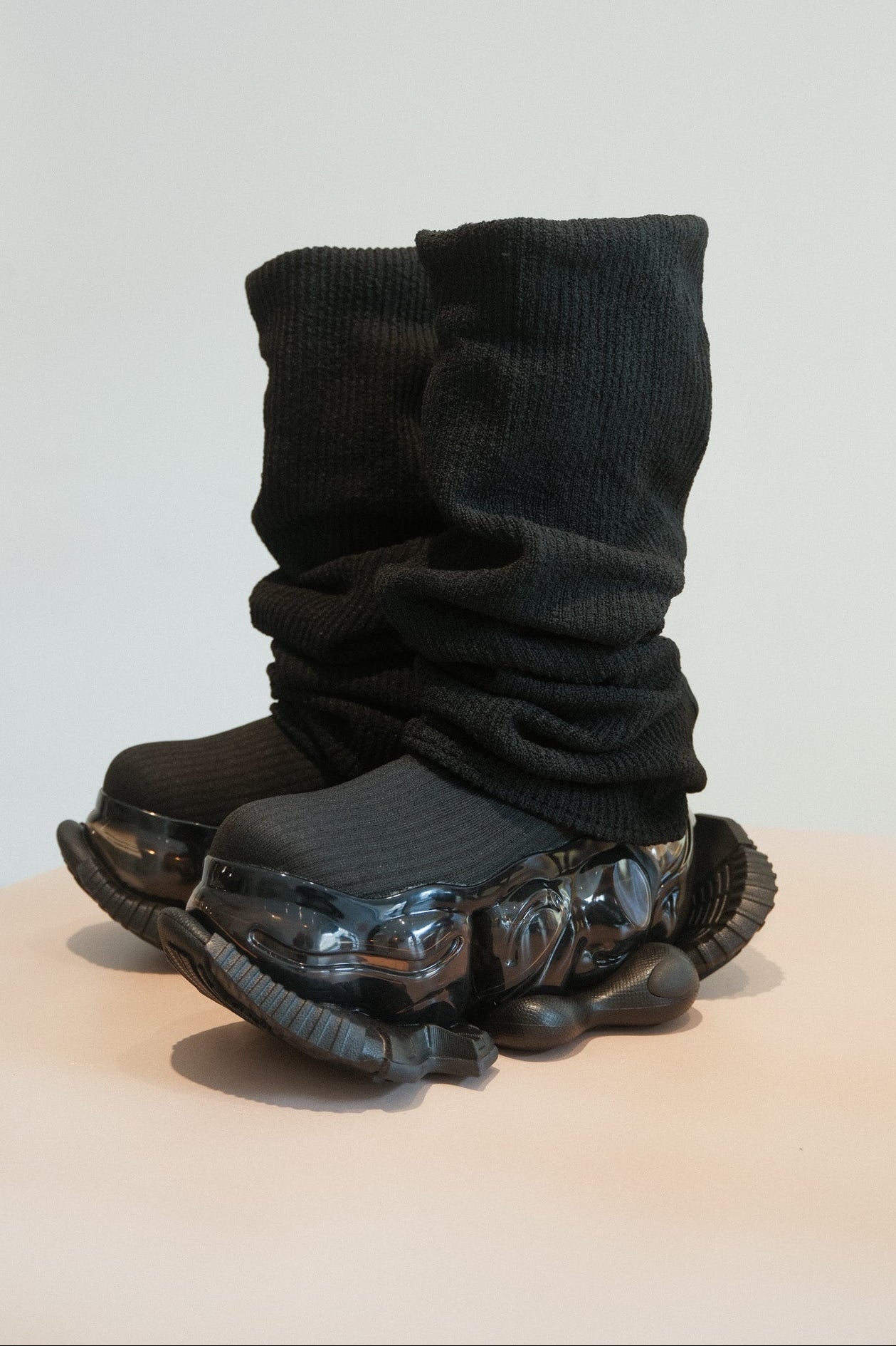 Black shoes with a futuristic design on a light gray background